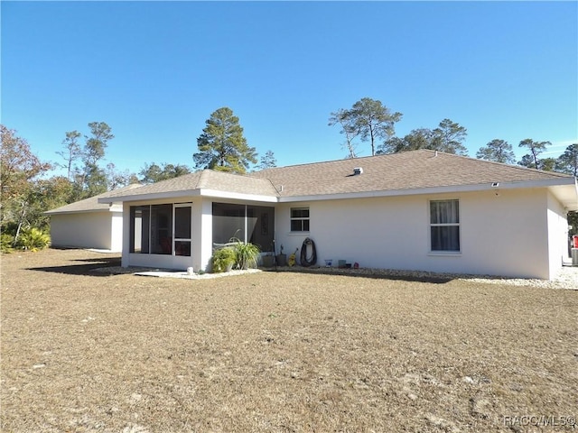 rear view of house featuring a sunroom