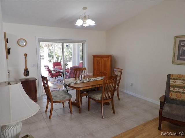 dining area featuring light tile patterned floors and a chandelier