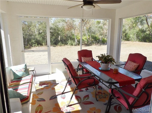 sunroom featuring ceiling fan