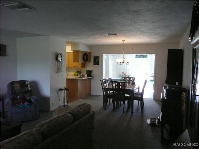 carpeted dining space featuring a textured ceiling and a notable chandelier