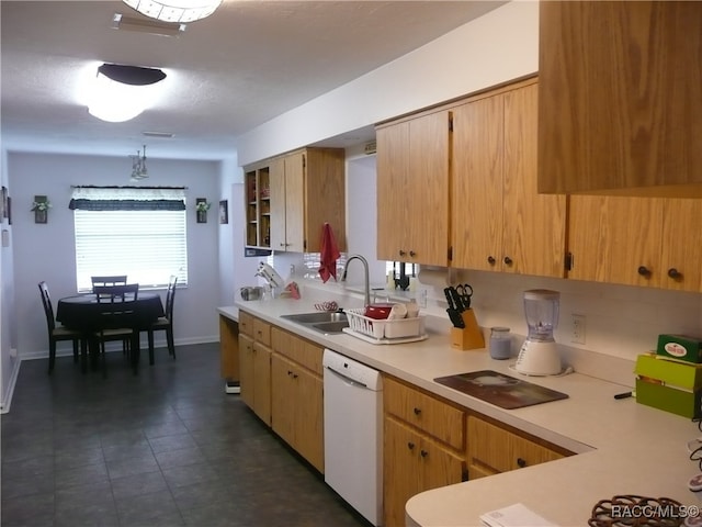 kitchen featuring black cooktop, dishwasher, hanging light fixtures, and sink