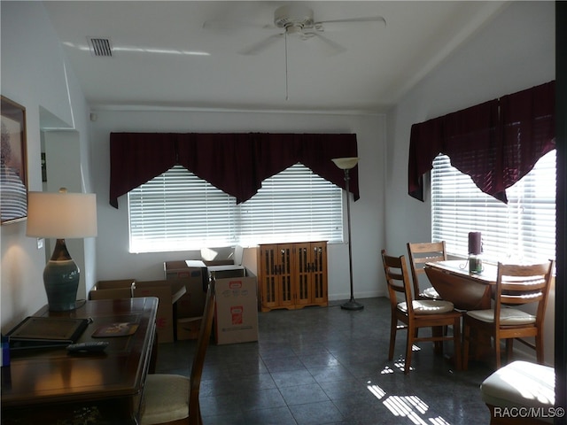 dining space with ceiling fan and vaulted ceiling