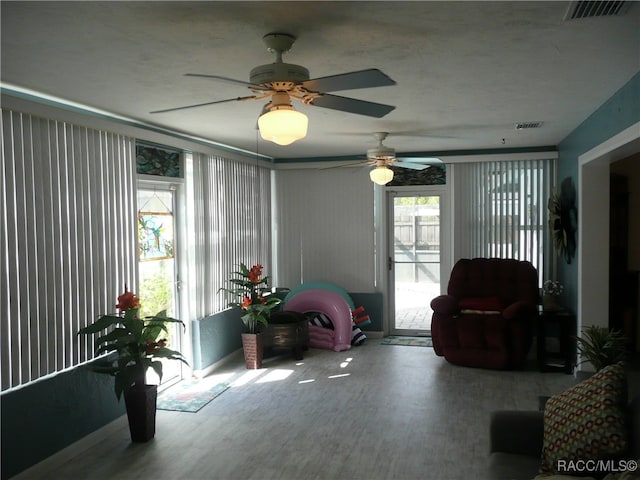 interior space with ceiling fan and hardwood / wood-style flooring