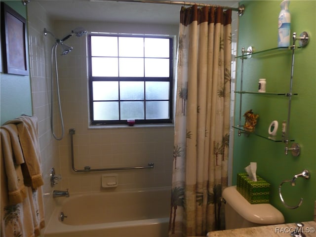 bathroom with toilet and shower / bath combo with shower curtain