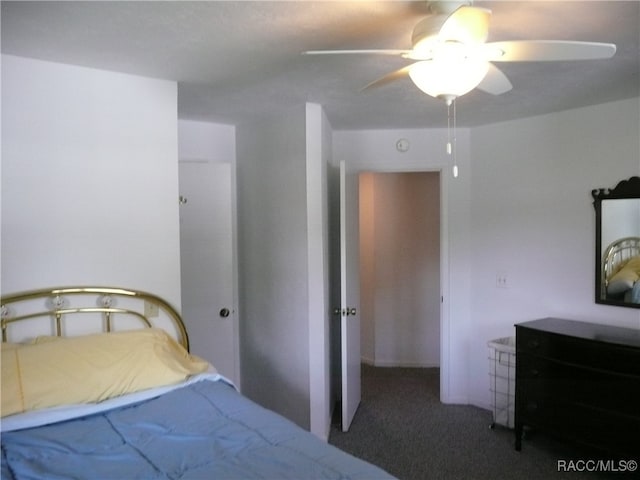 bedroom with ceiling fan and dark carpet