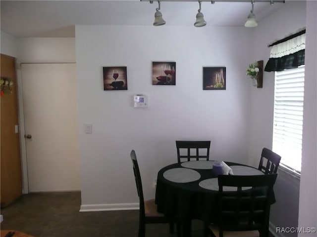 dining area featuring rail lighting