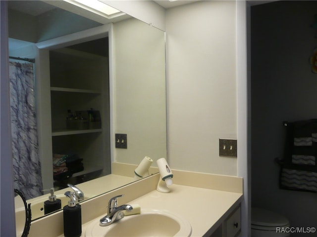 bathroom featuring vanity and toilet