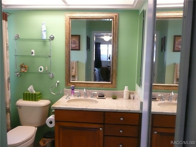 bathroom featuring vanity and toilet