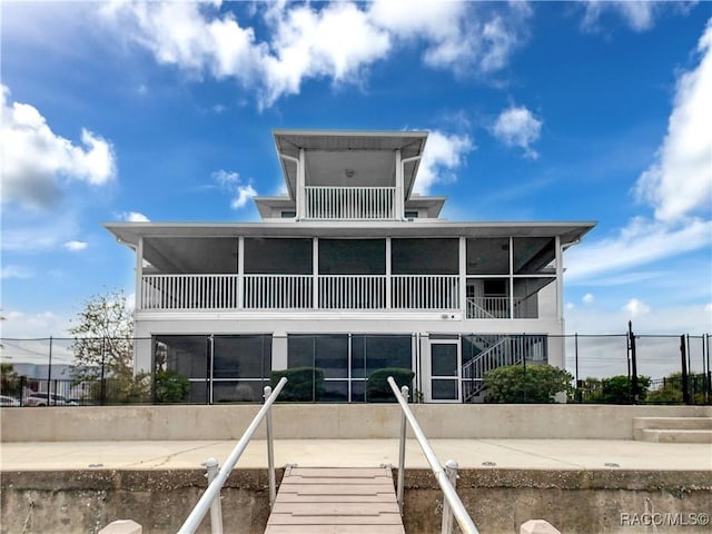 rear view of house featuring a sunroom