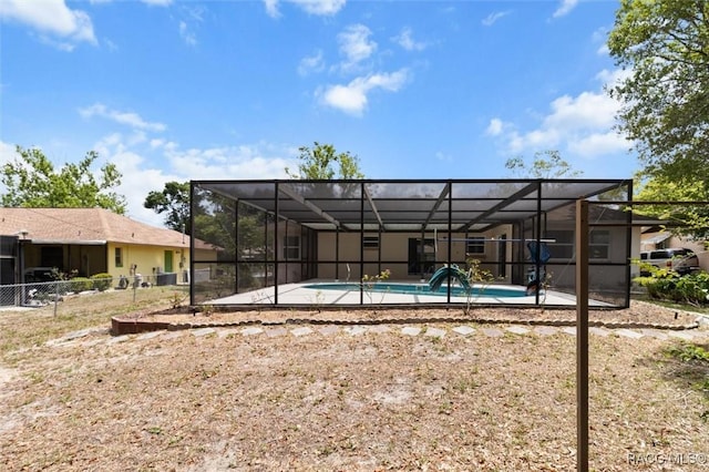 520 S Jefferson St, Beverly Hills, FL 34465 - rear view of house with fence, glass enclosure, a patio area, and an outdoor pool