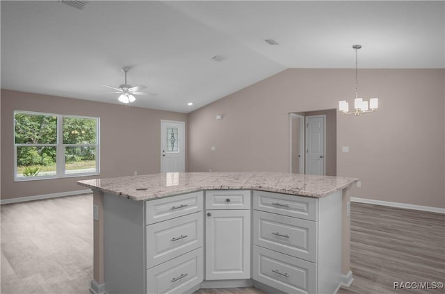 8880 N Circular Way, Citrus Springs, FL 34434 - kitchen featuring a chandelier, a ceiling fan, light wood-style floors, white cabinetry, and lofted ceiling