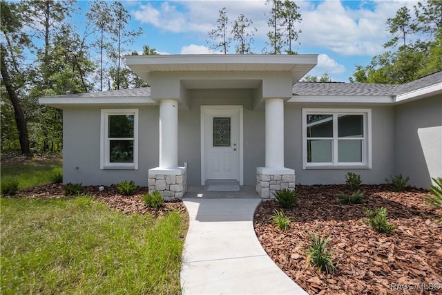 8880 N Circular Way, Citrus Springs, FL 34434 - entrance to property with stucco siding and a shingled roof