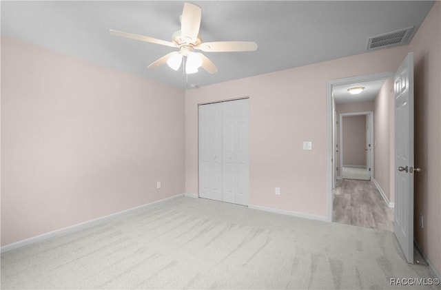 8880 N Circular Way, Citrus Springs, FL 34434 - unfurnished bedroom with carpet, a closet, and a ceiling fan