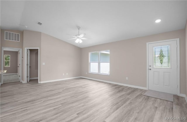 8880 N Circular Way, Citrus Springs, FL 34434 - unfurnished living room featuring lofted ceiling, light wood-type flooring, and ceiling fan