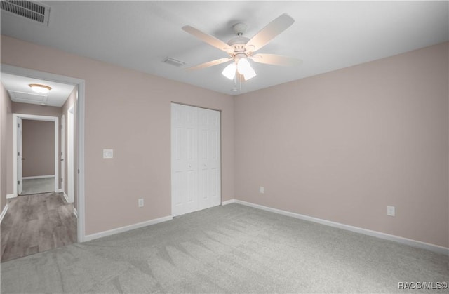8880 N Circular Way, Citrus Springs, FL 34434 - unfurnished bedroom featuring carpet floors, a closet, and a ceiling fan