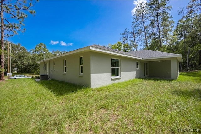 8880 N Circular Way, Citrus Springs, FL 34434 - back of house featuring stucco siding and a yard