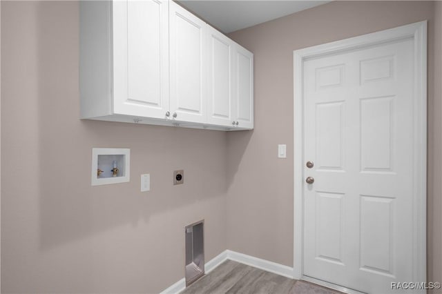 8880 N Circular Way, Citrus Springs, FL 34434 - laundry room featuring cabinet space, electric dryer hookup, washer hookup, and light wood-style floors