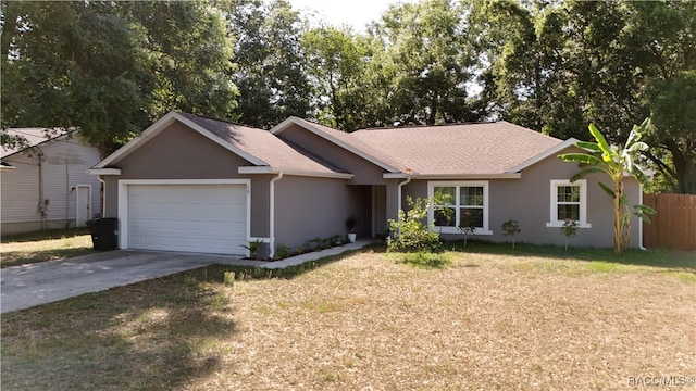 ranch-style house with fence, a front lawn, concrete driveway, an attached garage, and stucco siding