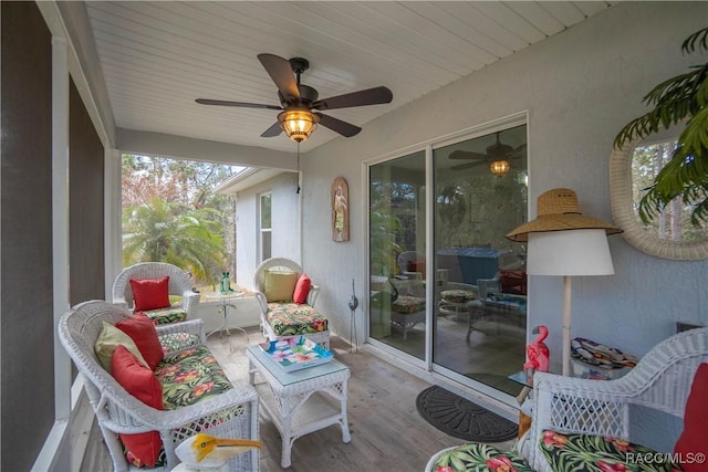 sunroom / solarium featuring ceiling fan