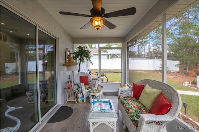 sunroom featuring ceiling fan