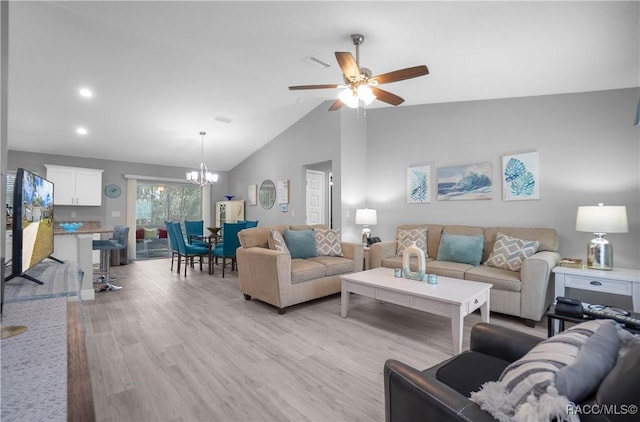 living room featuring ceiling fan with notable chandelier, high vaulted ceiling, and light hardwood / wood-style flooring