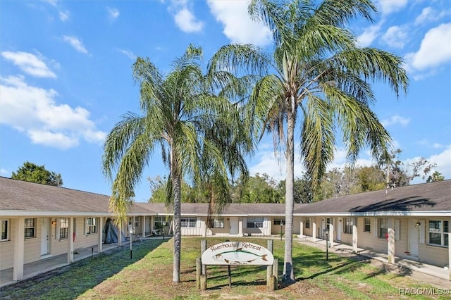 rear view of house with a lawn