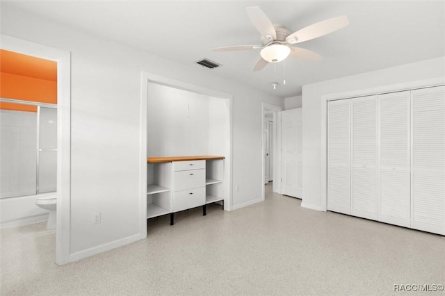 unfurnished bedroom with light speckled floor, a closet, visible vents, ensuite bathroom, and baseboards