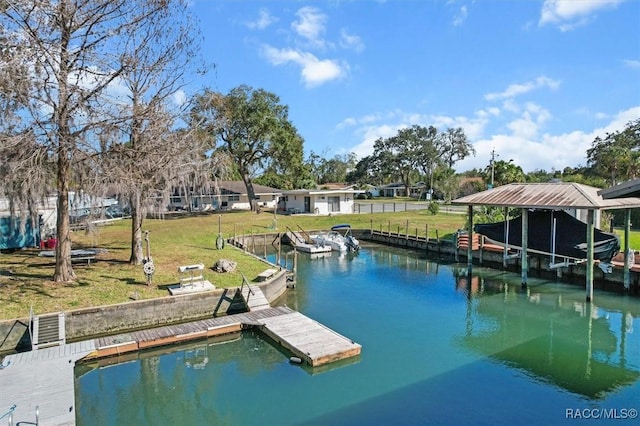 view of dock with a yard and a water view