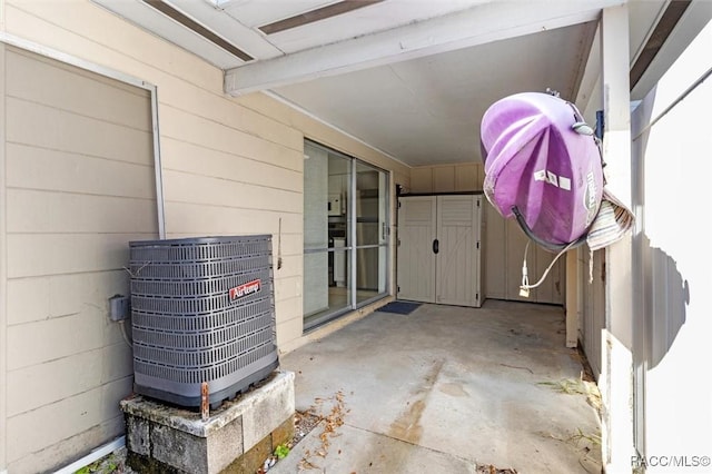 exterior space with central AC unit and a patio area