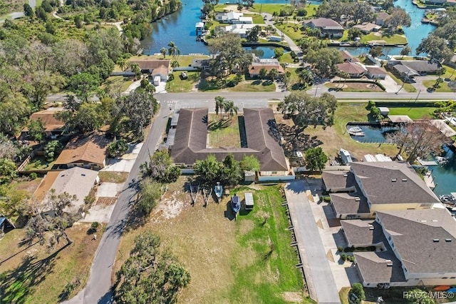 drone / aerial view with a water view and a residential view