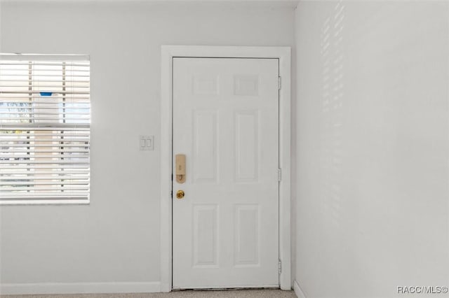 doorway to outside featuring baseboards