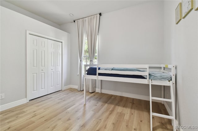 bedroom featuring light wood-type flooring and a closet