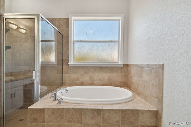 bathroom with independent shower and bath and a healthy amount of sunlight