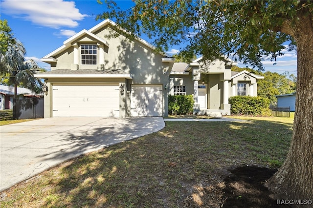 view of front of property with a garage and a front lawn