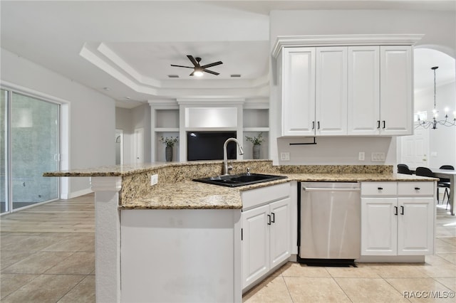 kitchen featuring sink, stainless steel dishwasher, pendant lighting, white cabinets, and ceiling fan with notable chandelier