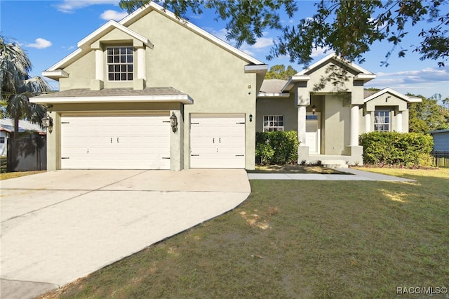 view of front of house with concrete driveway, a front yard, an attached garage, and stucco siding