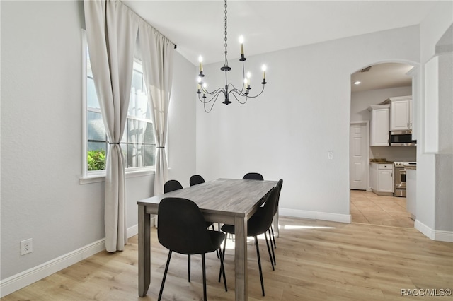 dining area featuring an inviting chandelier and light wood-type flooring