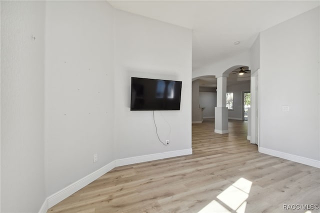 unfurnished living room featuring ceiling fan and light hardwood / wood-style flooring