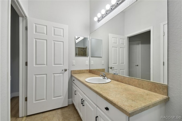 bathroom with tile patterned flooring and vanity