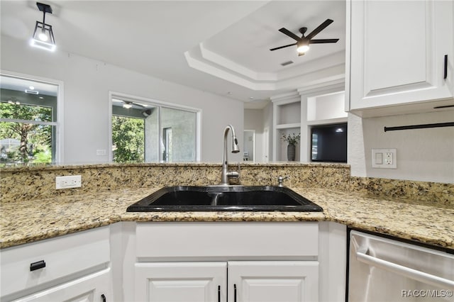 kitchen with white cabinetry, sink, stainless steel dishwasher, and light stone counters