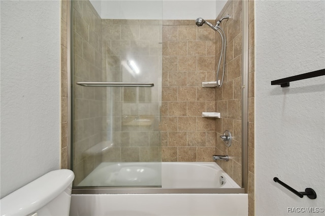 bathroom with shower / bath combination with glass door and toilet