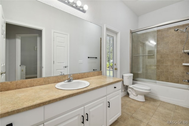 full bathroom featuring tile patterned floors, vanity, toilet, and shower / bath combination with glass door