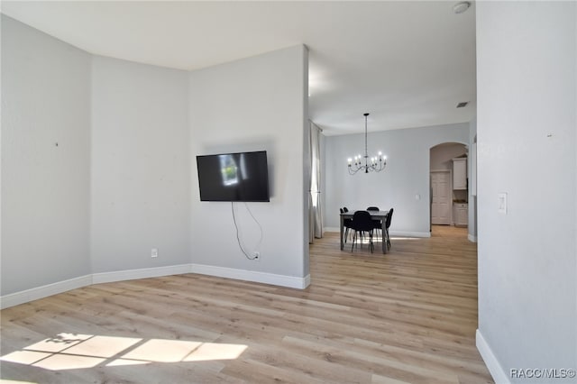 interior space featuring a chandelier and light hardwood / wood-style floors