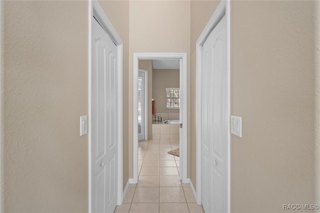 corridor with light tile patterned flooring