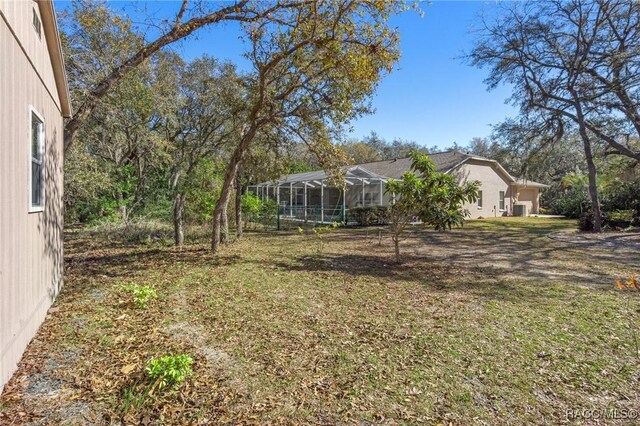 view of yard with a lanai