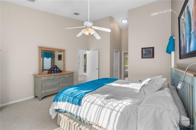 bedroom with visible vents, ceiling fan, baseboards, carpet flooring, and high vaulted ceiling