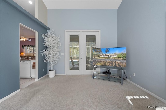 living area featuring french doors, carpet floors, baseboards, and ceiling fan