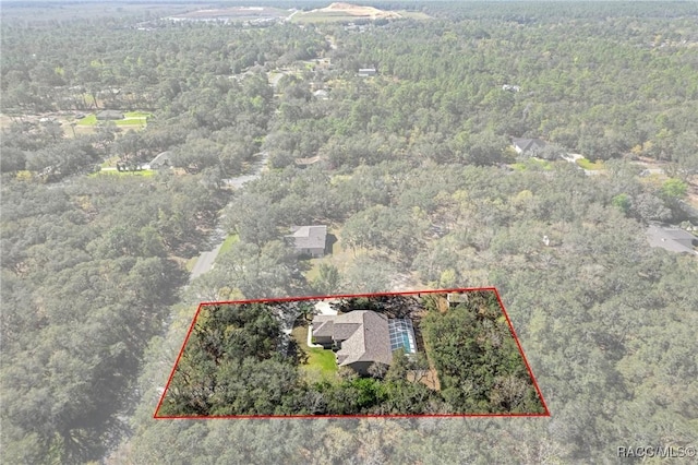 drone / aerial view featuring a forest view