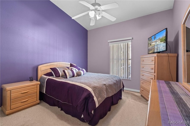 bedroom with light carpet, lofted ceiling, and a ceiling fan