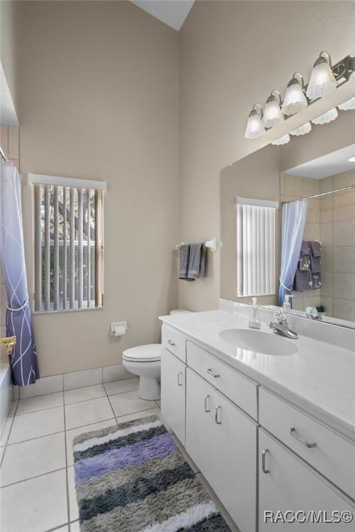 full bathroom with tile patterned flooring, toilet, and vanity